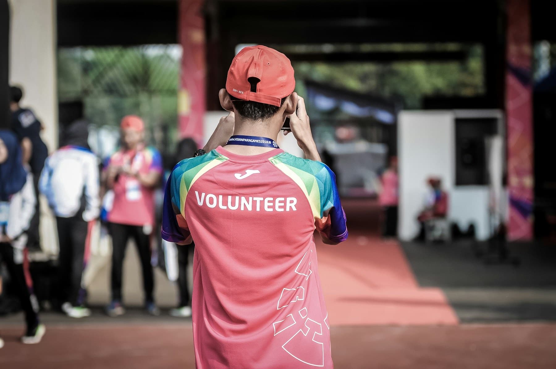 A volunteer in a bright VOLUNTEER shirt at a community event